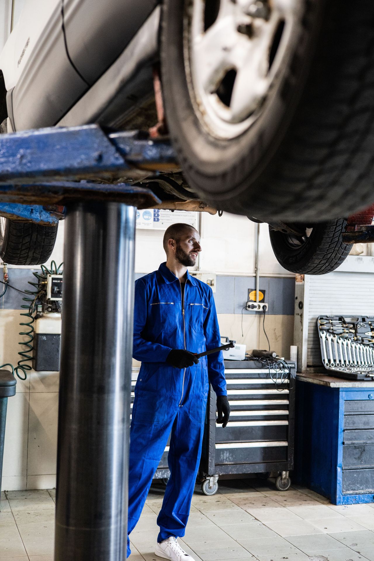 AS Service — mechanic under a car