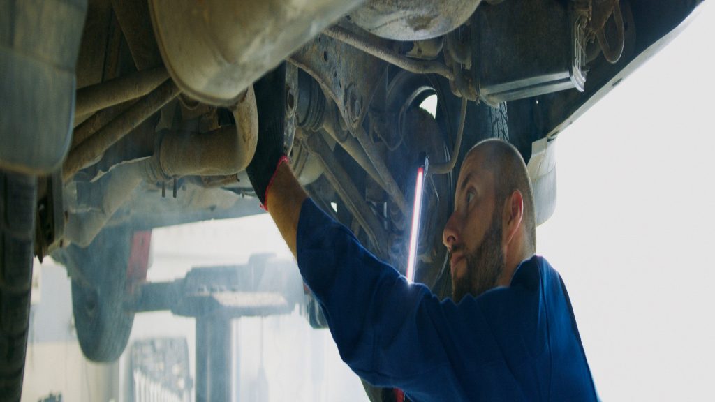AS Service — mechanic under a car